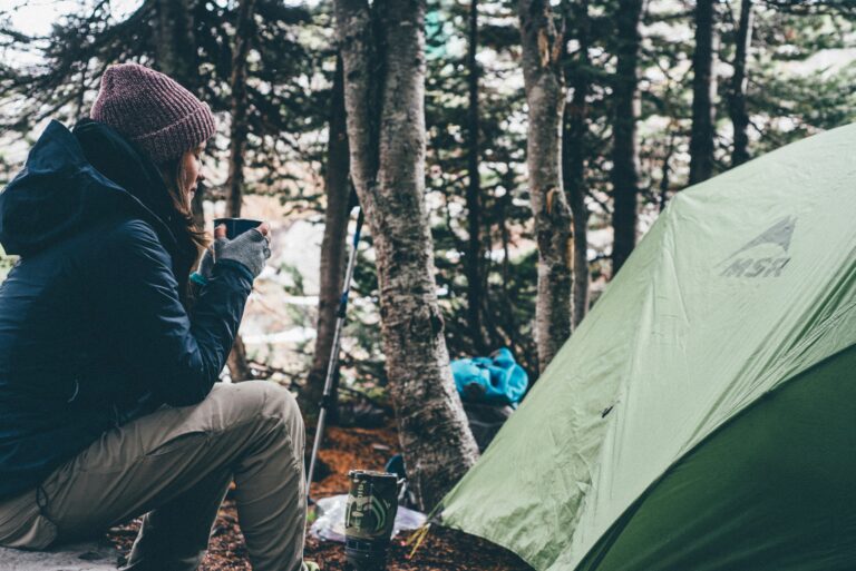 Hiker at a campsite beside tent