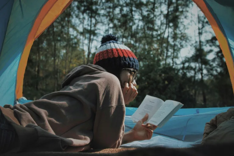 Woman reading inside a tent