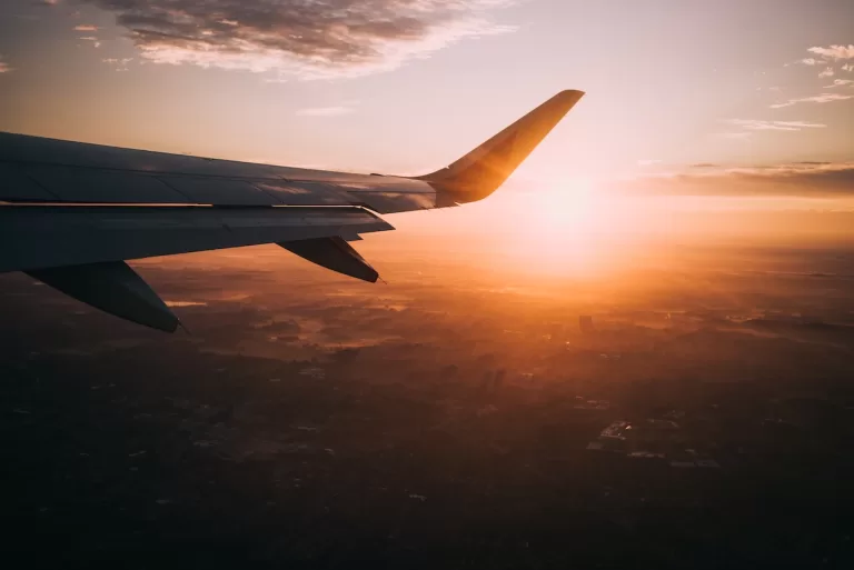 View of an airplane wing at sunset.