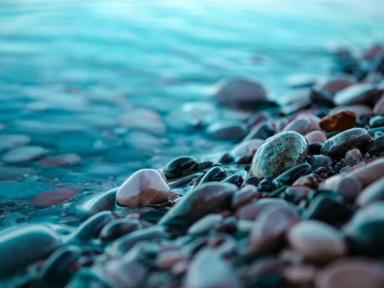Pile of rocks by lake shore