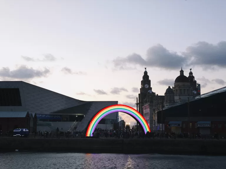 A city skyline with a rainbow arch