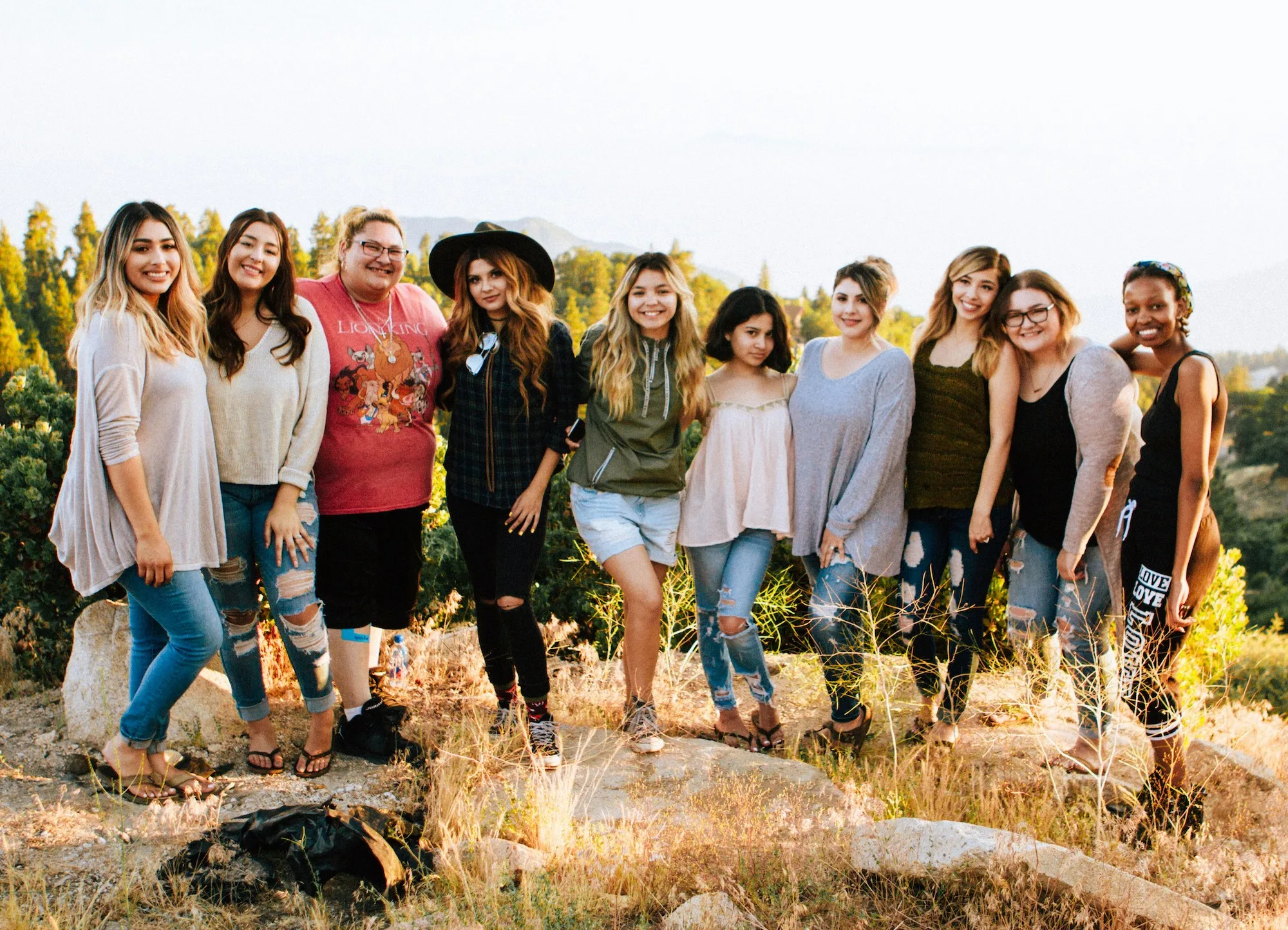 A diverse group of women posing for a photo on a hike