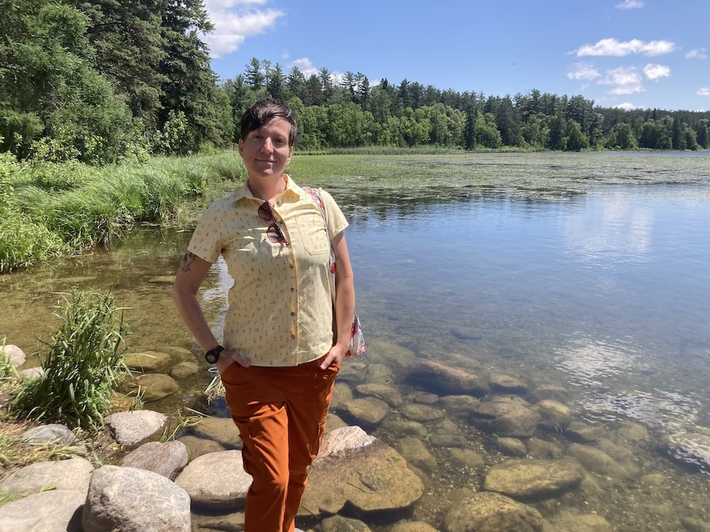 White person wearing orange pants and a yellow button down, being queer in the country 