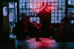 People gather inside a dimly lit establishment.
