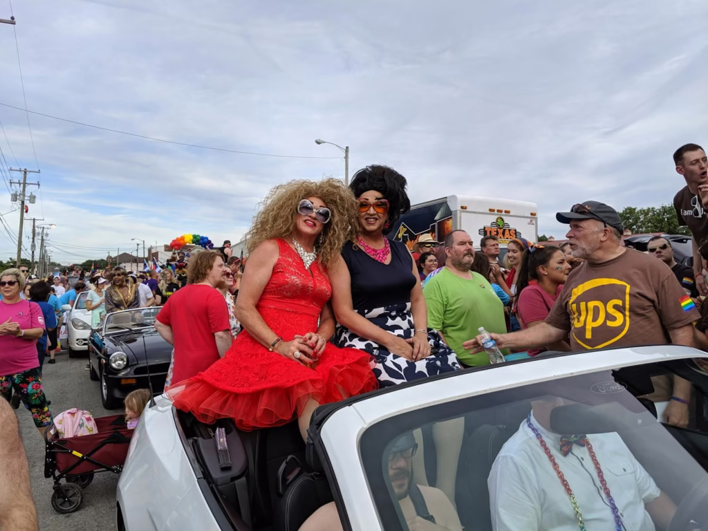 Lively gathering at a colorful parade in Louisville featuring diverse participants and festive outfits.
