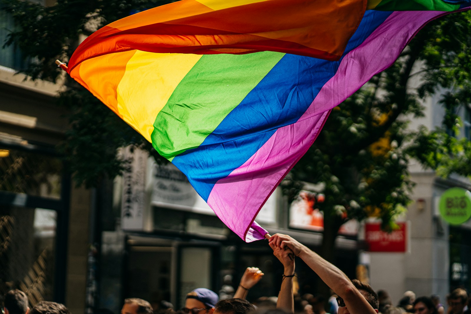 people holding Pride flags during daytime