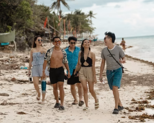 A group of friends walking on a tropical beach